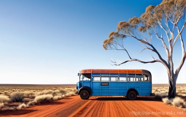 호주 영화 촬영된 지역 - **"Outback Road Trip Dream"**: An old, weathered, bright blue vintage bus drives along a dusty, vibr...